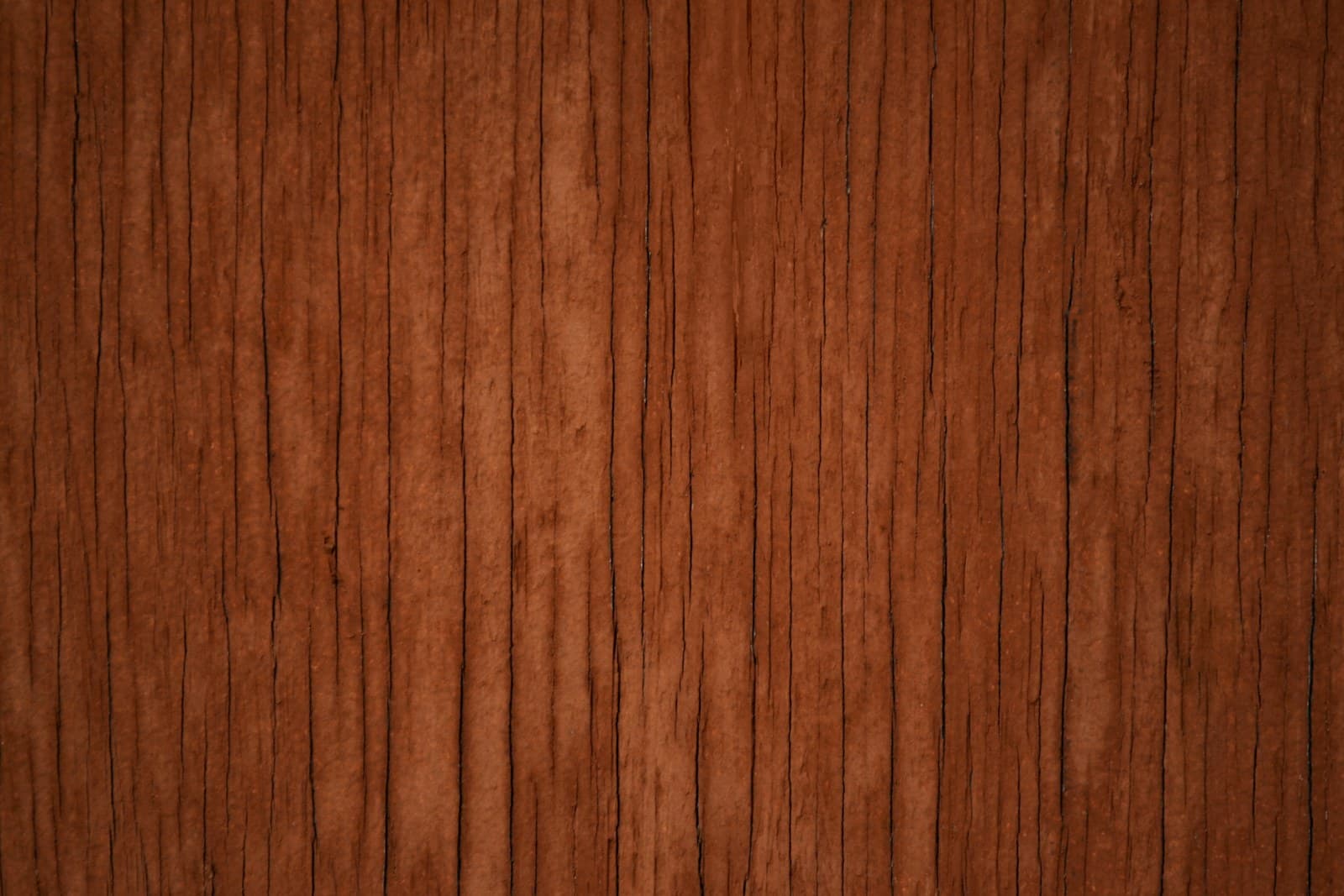 Oiled teak surface with woven textile in soft window light