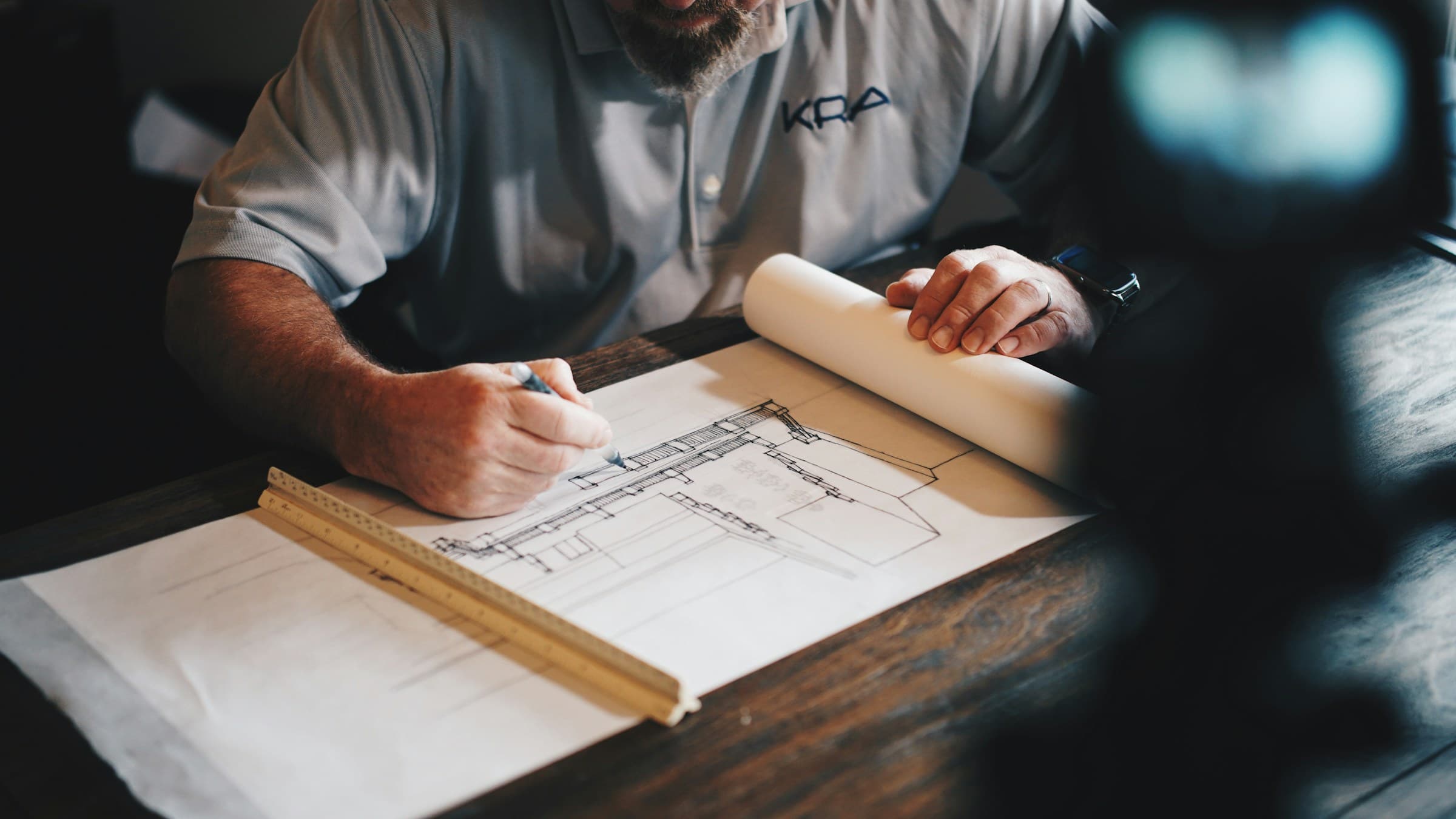 Architect drafting full-scale details with pencil and ruler