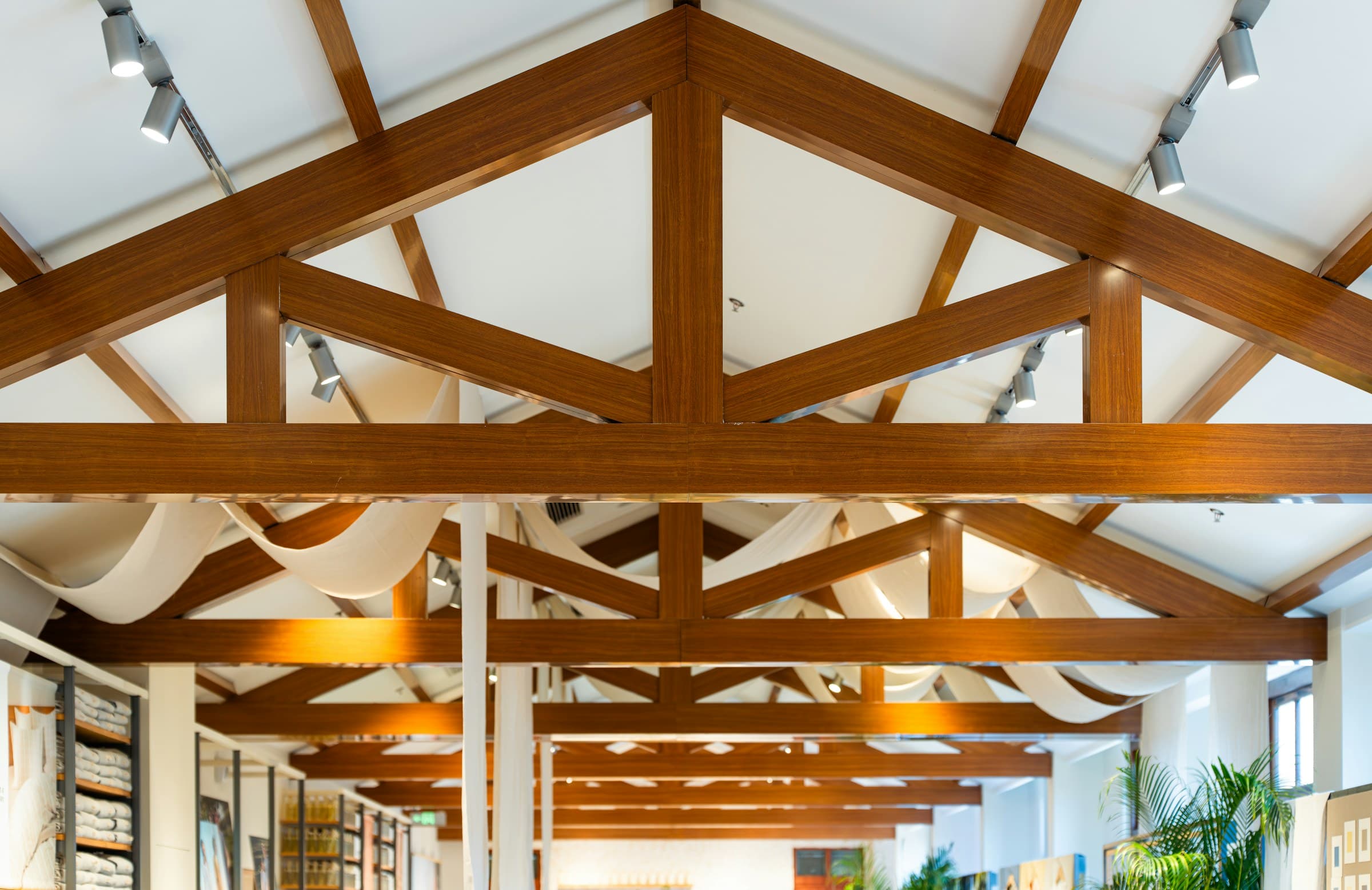 Laminated timber beams sweeping across the living-floor ceiling